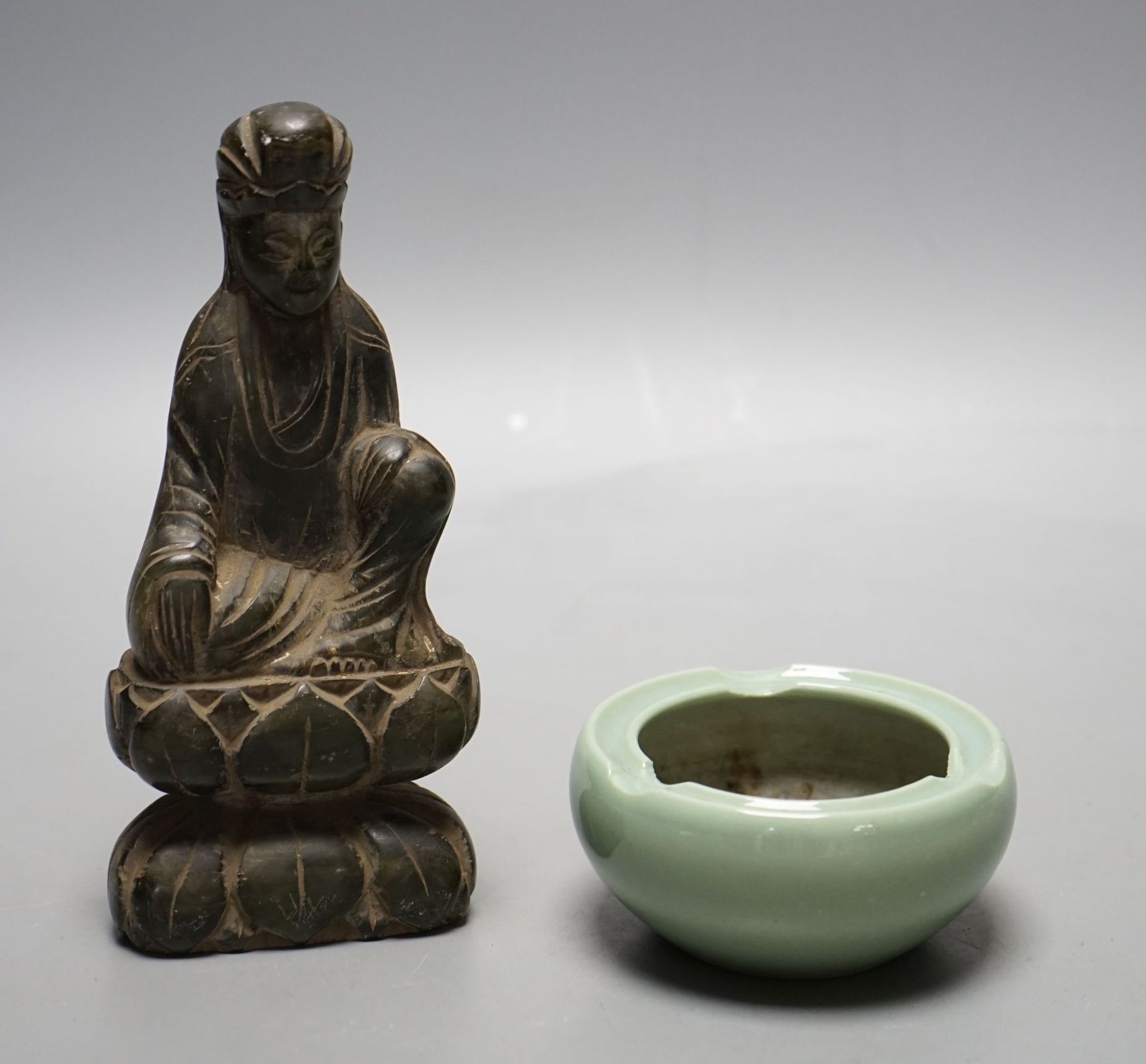 A Chinese soapstone carving of Buddha and a celadon glazed bowl, Buddha 16.5 cms high.